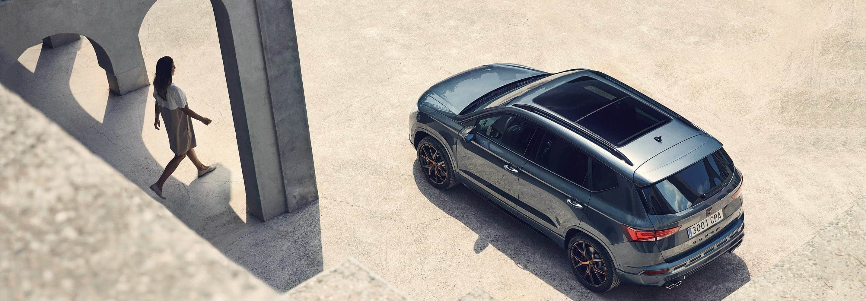A woman walking to drive her CUPRA Ateca