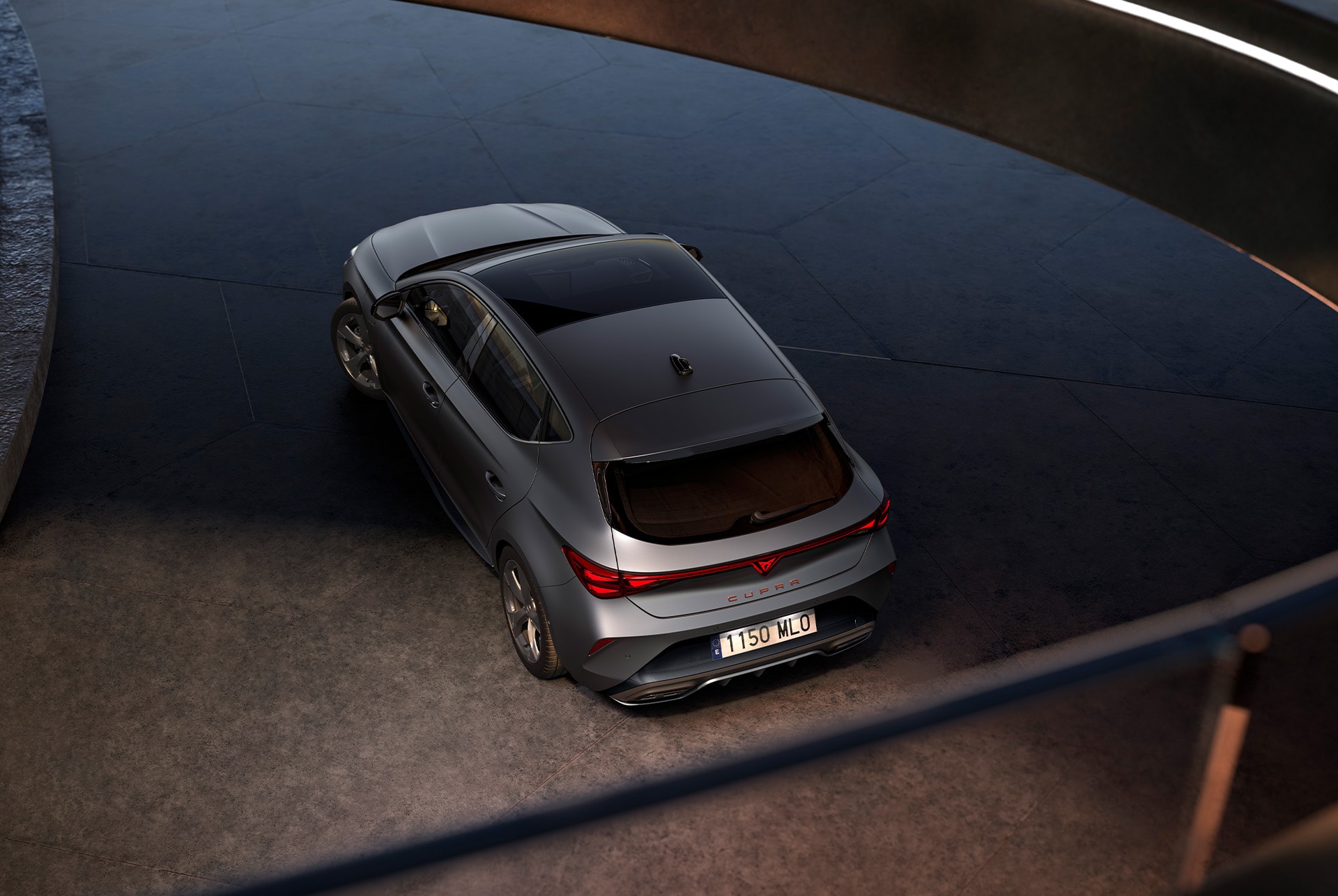 CUPRA Leon 5D with dark pack enhancements. The image displays the CUPRA Leon 5D featuring the dark pack, which includes dark aluminum side skirts for a sharp, sporty appearance, a glossy black roof spoiler for enhanced aerodynamics, and dark shadow garbi alloy wheels for superior traction and safety.